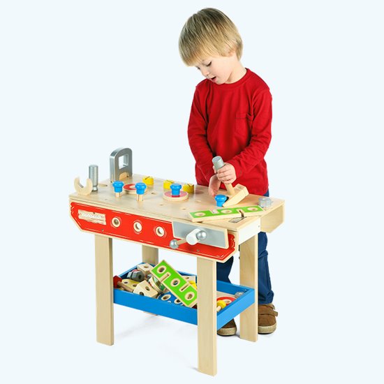Little boy playing with work bench