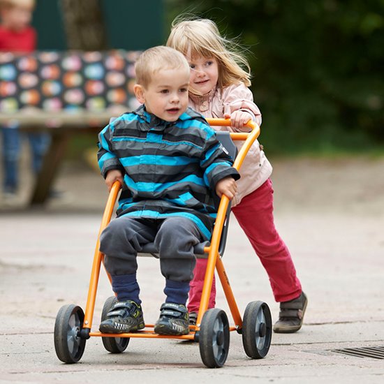 Two children playing with stroller