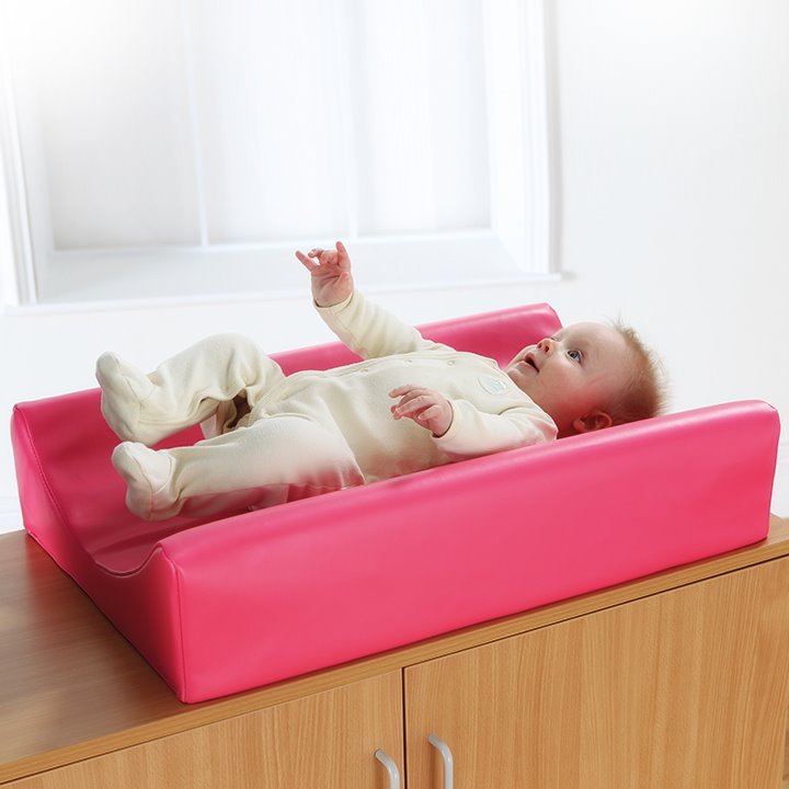 Pink curved changing mat with child
