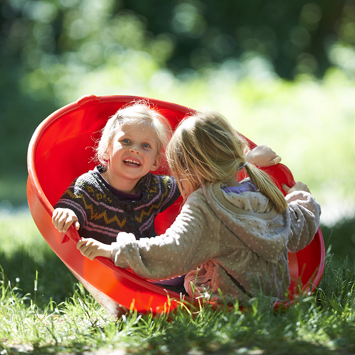 Two children playing in rocking top