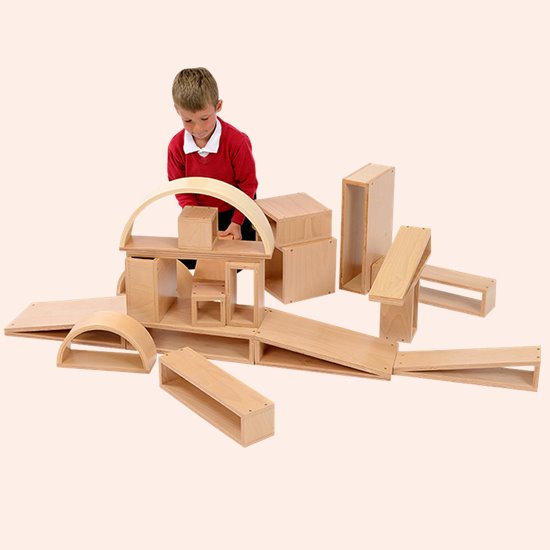 Little boy building with open blocks
