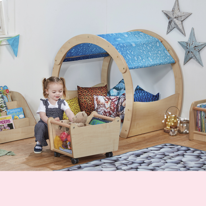 Little girl in under the sea zone full of cushions and blankets