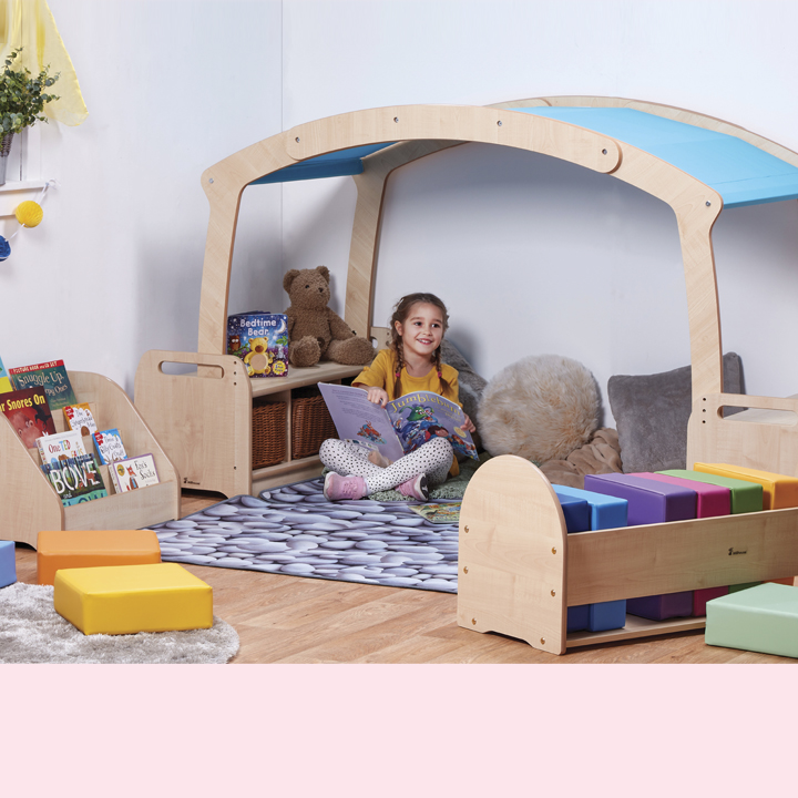 Little girl making herself comfy in reading zone