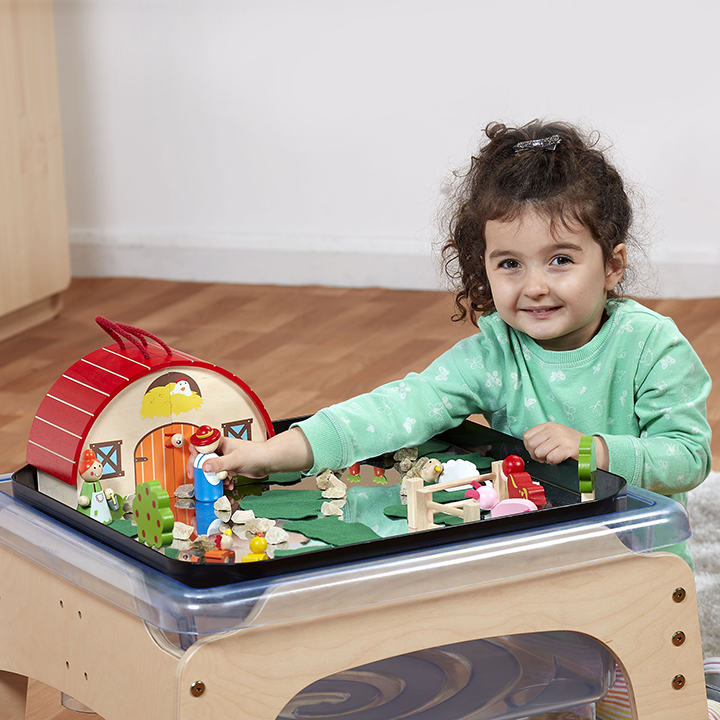 Little girl playing in tray