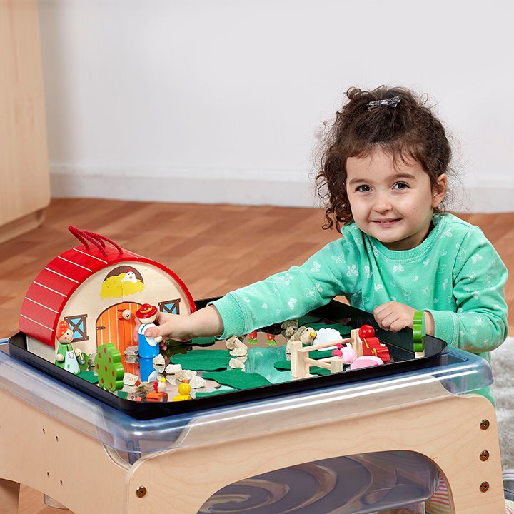 Little girl playing in tray