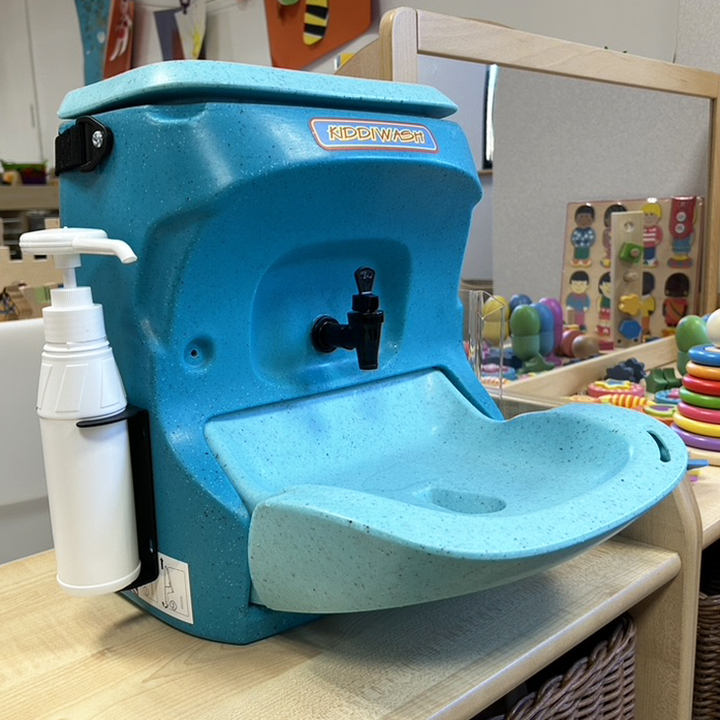 Blue hand wash sink with soap dispenser