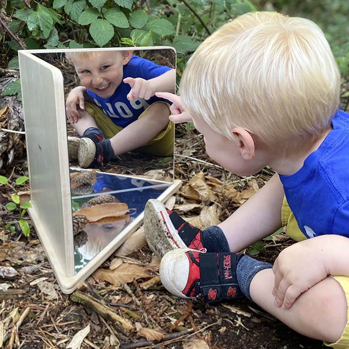 Child outdoors with A 90º corner mirror