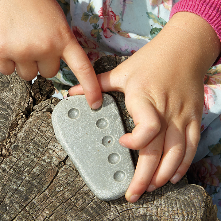 One finger counting dimples on block