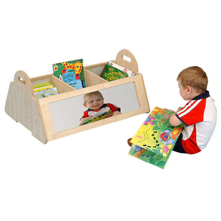 Little boy reading a book next to the kinderbox