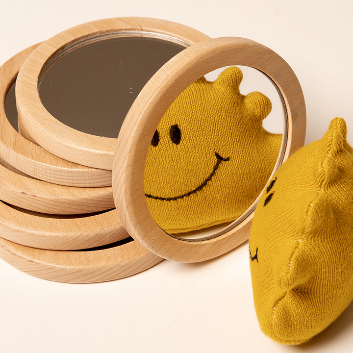 Pile of small circular mirrors and wooden frames