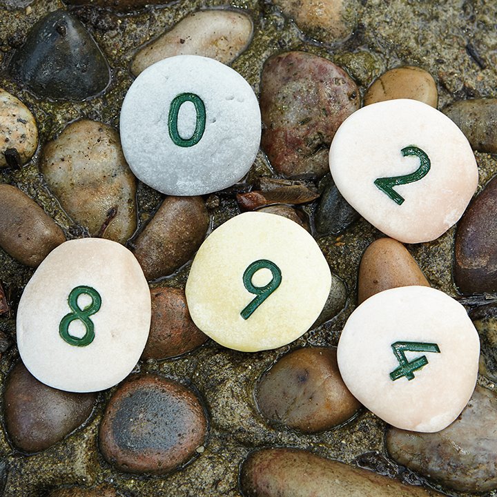 Numbered pebbles laid on outdoor flooring