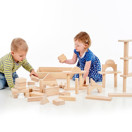 Two toddlers playing with wooden blocks