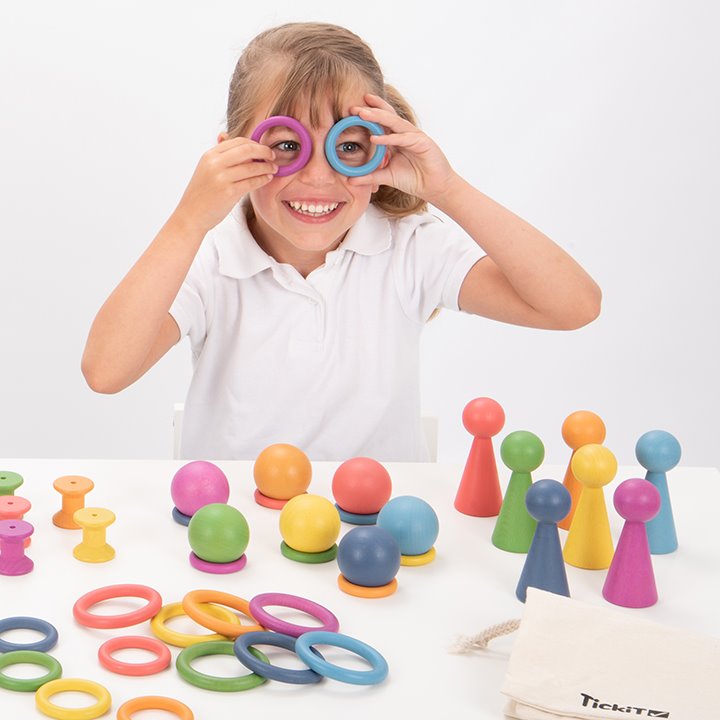 Creative play with Tactile smooth solid beechwood loose parts in the seven colours of the rainbow