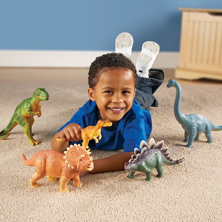 Little boy playing with dinosaurs