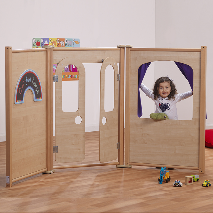 Little girl pushing curtains aside and looking through window