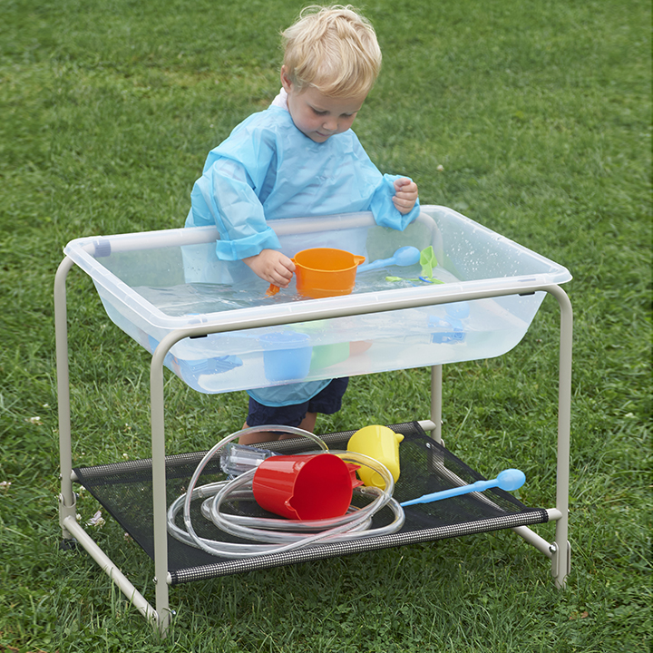 Folding stand and tray used in an outdoor setting filled with water