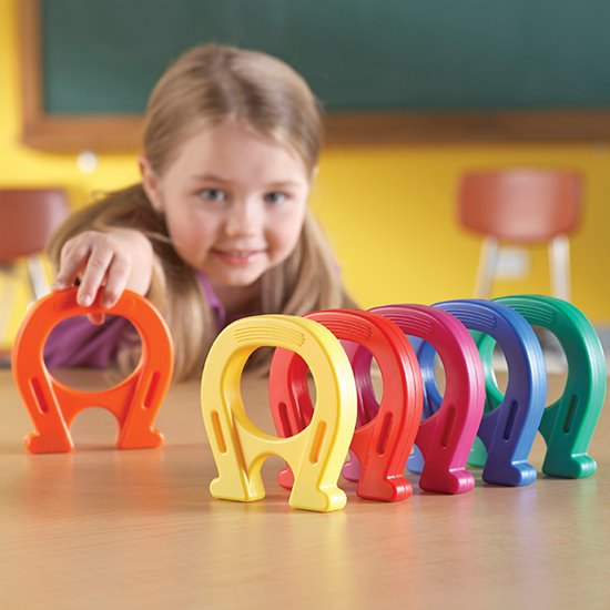 Different coloured horseshoe magnets lined up