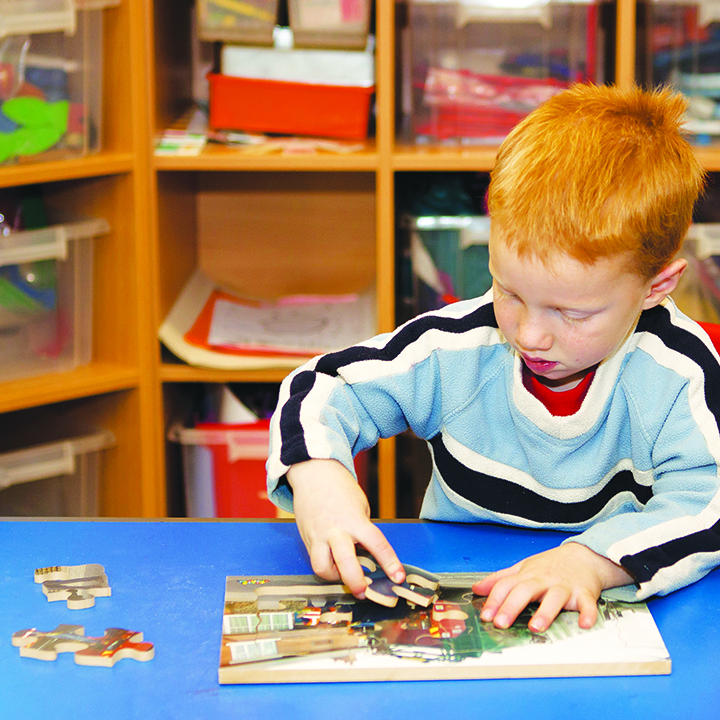 Boy completing puzzle