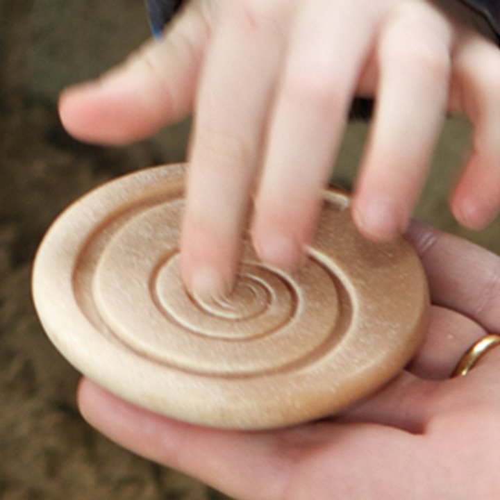 Hands on spiral stone
