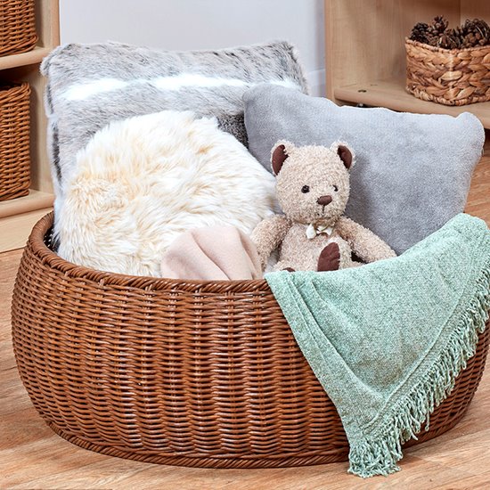 Rattan basket with blankets and cushions to create a cosy zone