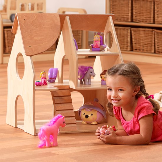 Child with Wooden Dolls House for small world play, multiple peep holes on 3 levels.