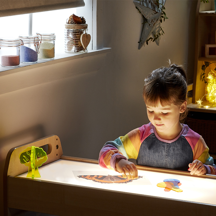 Little boy playing with light box trolley