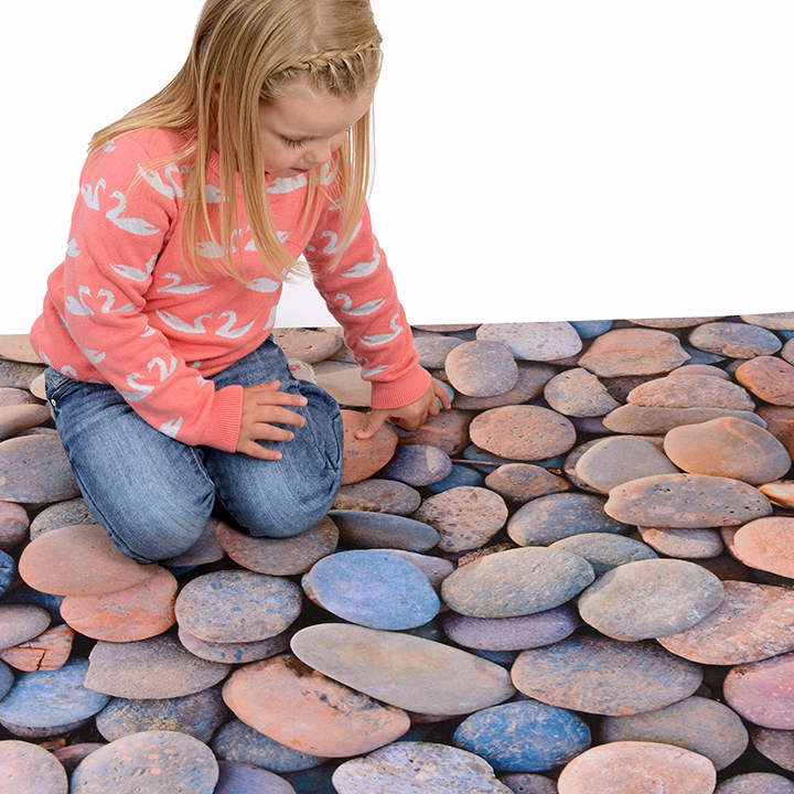 Pebble play mat with child sitting