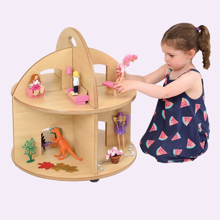 Child and wooden dolls house
