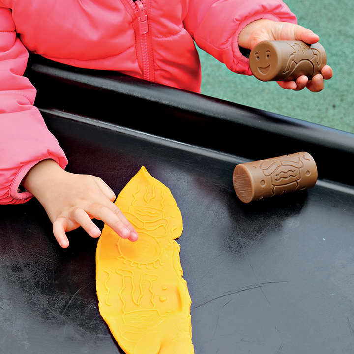 Rollers making marks in clay
