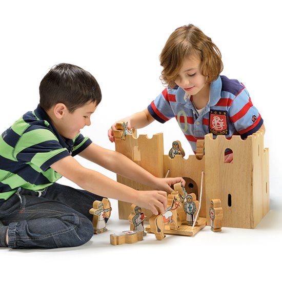 Two children playing with natural castle set