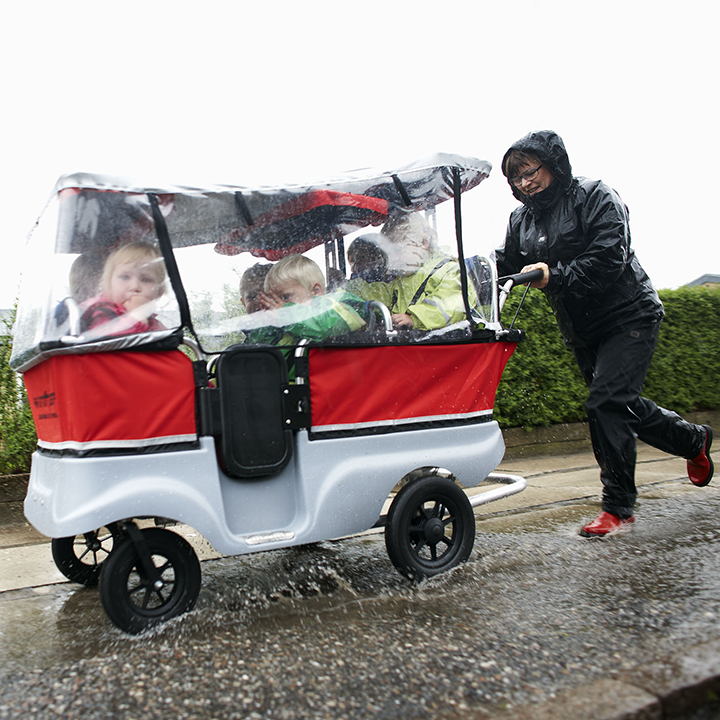 Children riding the kiddy bus with waterproof siding