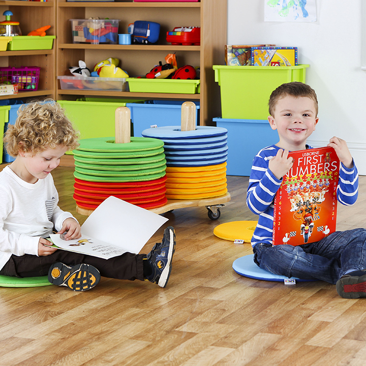 Children round cushions indoors