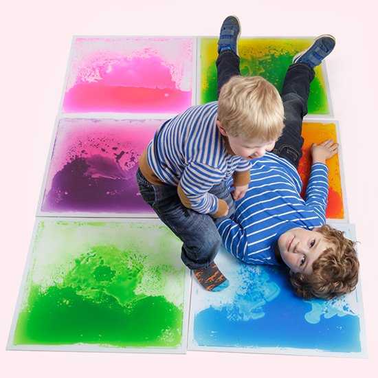 Two boys playing on liquid floor tiles