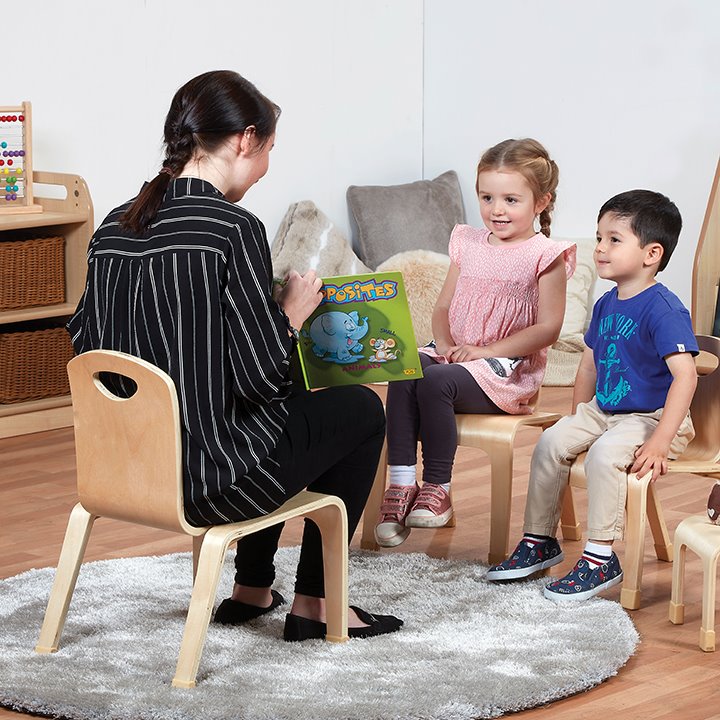 Teacher sitting on chair in classroom situation