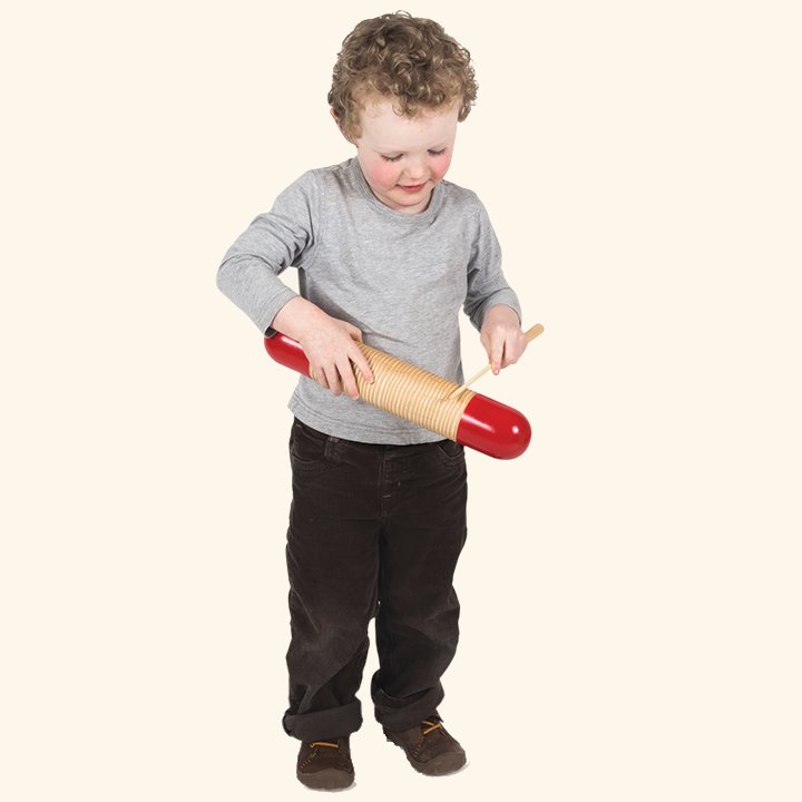 Little boy playing musical instrument
