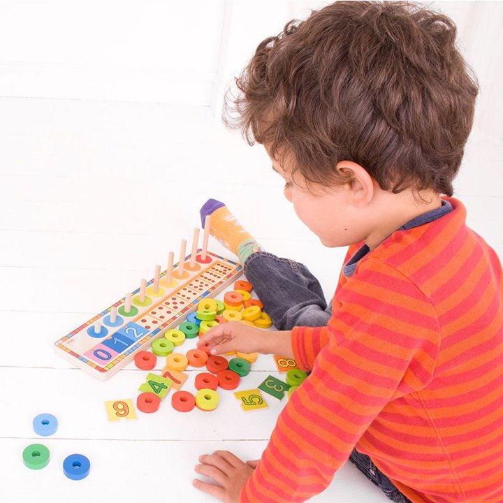 Little boy using learn to count activity set
