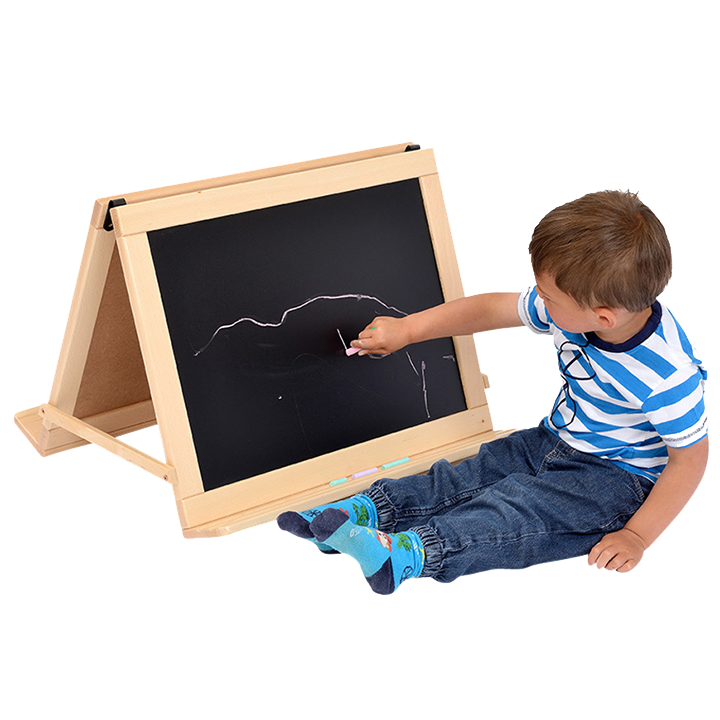 Boy drawing on folding easel on floor