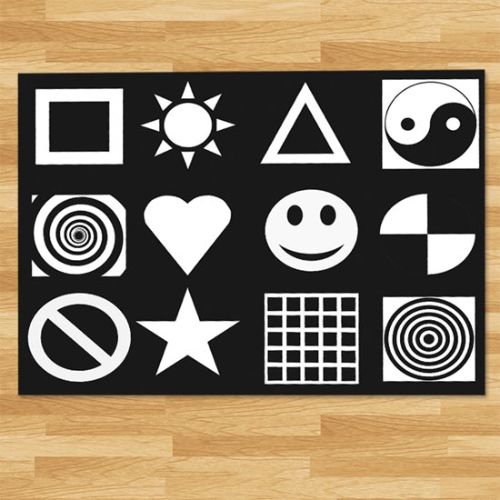 Black play mat with white patterns and symbols