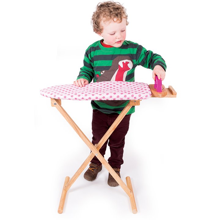 Child using wooden ironing board