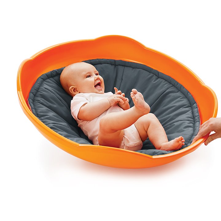 Baby lying on fabric lining of plastic top