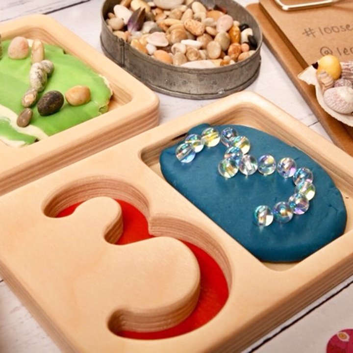 Number 3 tray with small objects sorted into a shape of 3
