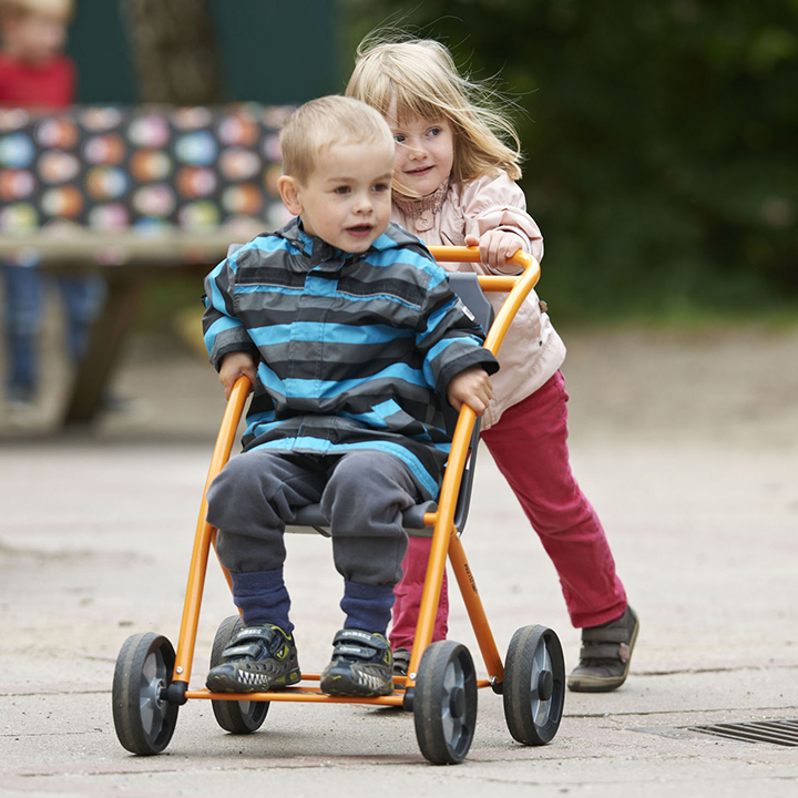 Two children playing with stroller