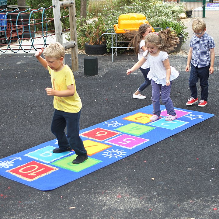 Children using and lining up for hopscotch outdoor carpet