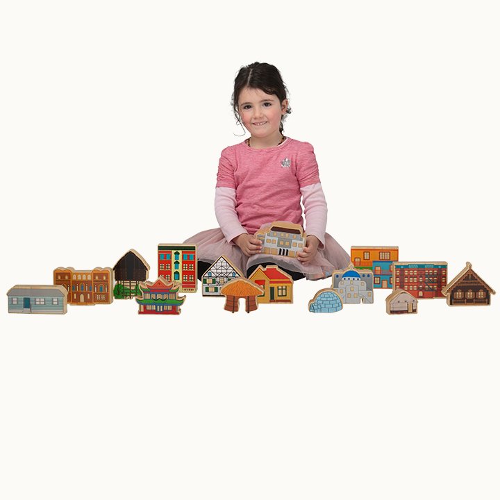 Little girl sitting with homes around the world blocks