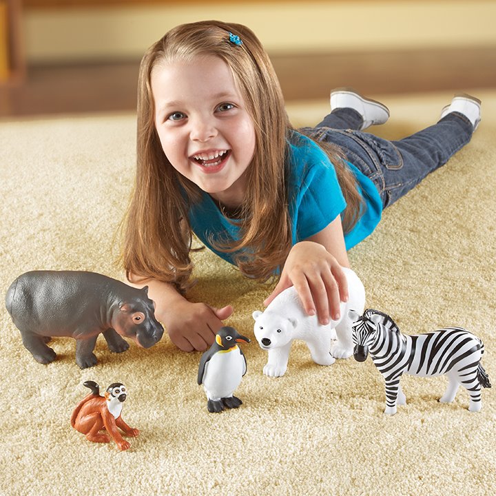 Little girl playing with zoo animal toys