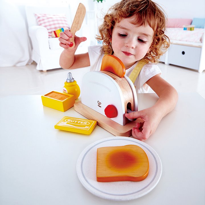 Child using pretend toaster