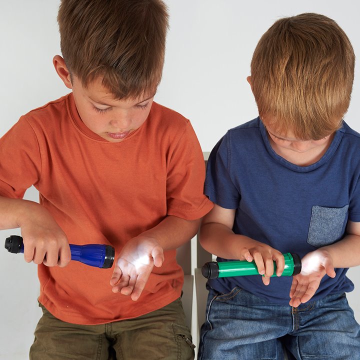 Two boys holding a handy torch light to their hand