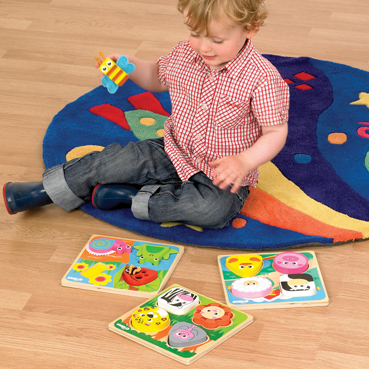 Child playing Set of Safari, Farm and Bugs.