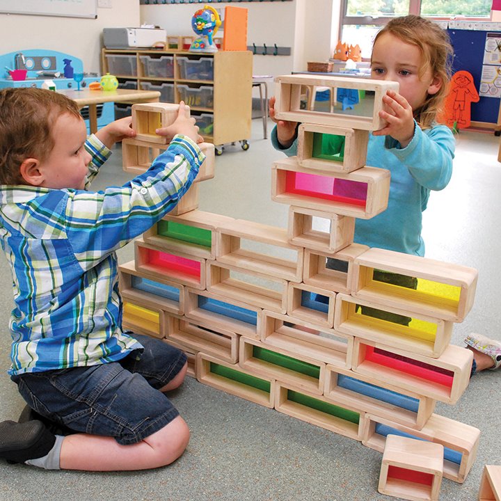 Children building with large building bricks with coloured acrylic inserts