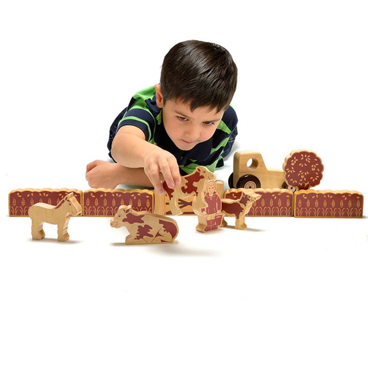 Little boy playing with farm set